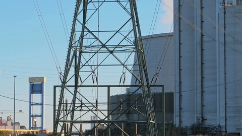 The power line. High voltage pole and industrial buildings on the background. 動画素材 112659517