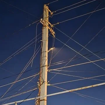 Power Line Pole Against Deep Blue Evening Sky Stock Photos