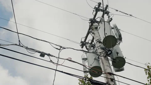 A power line pole with transformers on it. Typical of the United States Stock Footage 165972885