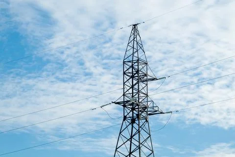 Power line support on the background of a blue sky with clouds Stock Photos