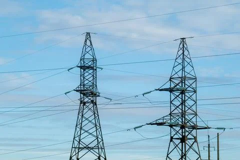 Power line support on the background of a blue sky with clouds Stock Photos