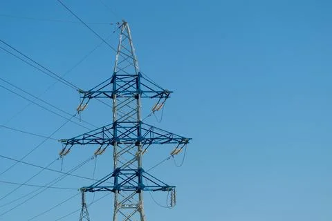 A power line tower is visible with a bright blue sky in the background. The t Stock Photos