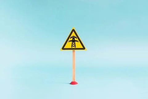 The "Power line" warning sign in the form of a yellow triangle Stock Photos