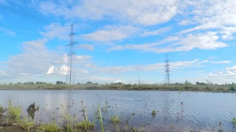 Power line, water and clouds in summer timelapse Stock Footage 82983334