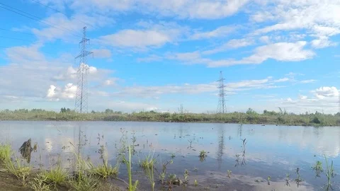 Power line, water and clouds timelapse Stock Footage 82987306