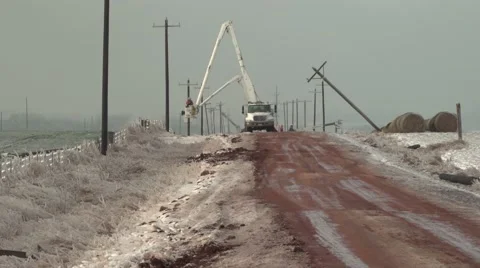 Power line workers in ice storm on muddy road Video stock 59683785