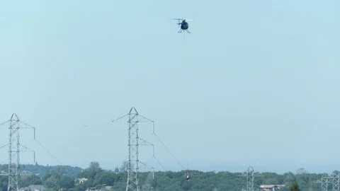 Power Lineman hanging from a helicopter Stock Footage 127220538