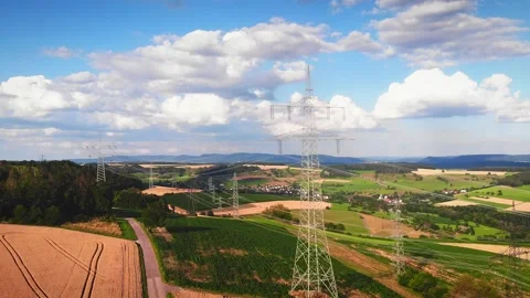 Power lines against blue cloudy sky.High voltage electricity transmission pylons 库存影片 200770671