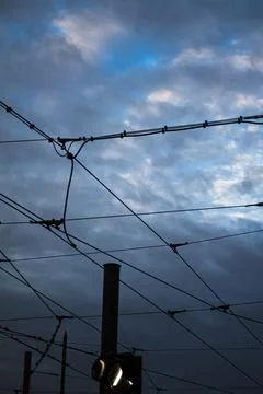 Power lines against a cloudy evening sky Stock Photos