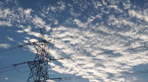 Power Lines Against a Dramatic Cloudy Sky Stock Photos