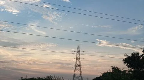 Power Lines Against a Dramatic Cloudy Sky Stock Photos