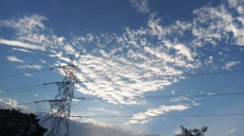 Power Lines Against a Dramatic Cloudy Sky Stock Photos