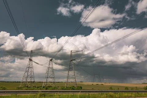 Power lines against the dramatic sky. 스톡 사진