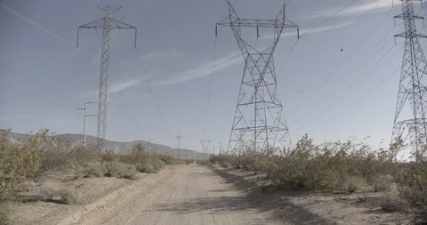 Power lines Along Dirt Road Stock Footage 89942535