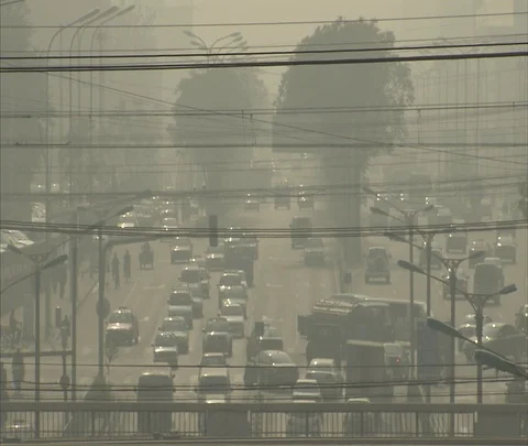Power lines and 10 lanes of traffic seen through thick smog. Stock Footage 86744161