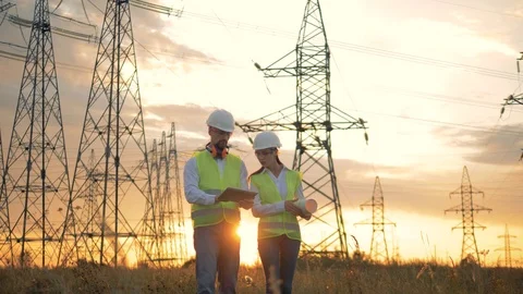 Power Lines and Engineer on a sunset. Stockbeeldmateriaal 93997144
