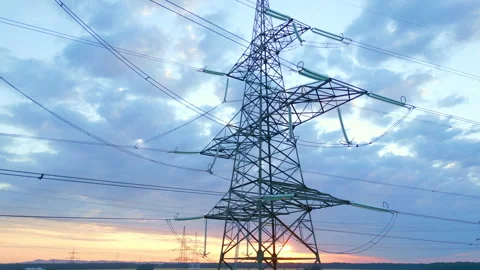 Power Lines and Pylons at Sunset, Symbolizing Renewable Energy Infrastructure Video stock 315613587