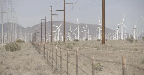 Power Lines and Wind Mills in California Pan Right Stock Footage 89942490