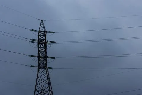 Power lines on the background of the cloudy sky. Stock Photos