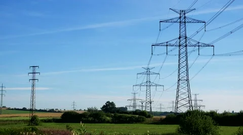 Power lines in countryside - blue sky Stock Footage