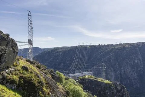 Power lines distributing electrical energy across a canyon Stock Photos