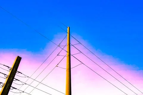Power lines in Florida summer against blue sky Stock Photos