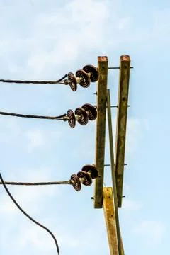 Power lines installed with ceramic insulators strung on cement pillars Stock Photos