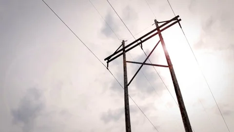 Power Lines with lens flare in cloudy sky Stock Footage 73647839