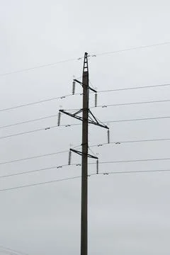 Power lines with multiple wires during a cloudy day. Preparing for a storm. P Stock Photos