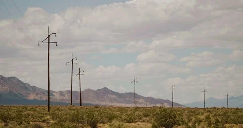 Power Lines Over a Desert Setting Locked Down Static Shot Stock Footage