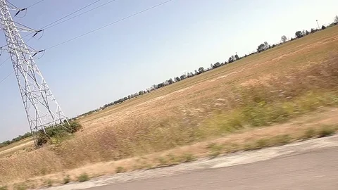 Power Lines Over Field Canted Vehicle Shot Stock Footage 81512066
