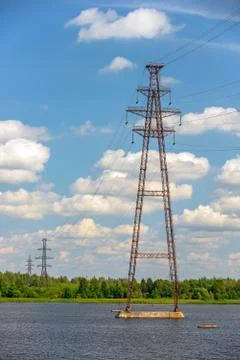 Power lines over river Stock Photos