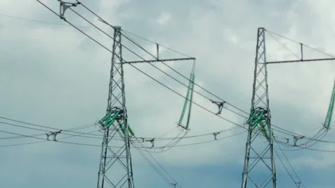 Power lines pylons against the background of clouds moving across the sky Stock Footage 124609625