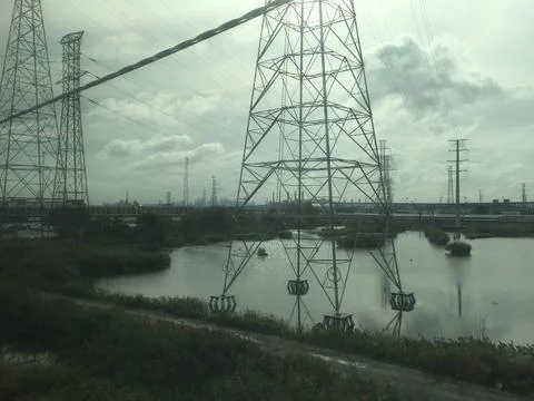 Power lines running alongside train tracks in Kearny NJ Stock Photos