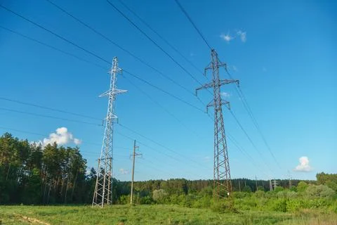 Power lines running through the forest. The support of an overhead power line Stock Photos