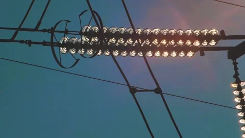 Power lines with sun rays on blue sky. H... | Stock Video | Pond5