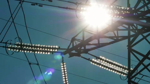 Power lines with sun rays on blue sky. H... | Stock Video | Pond5