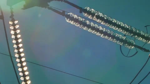 Power lines with sun rays on blue sky. H... | Stock Video | Pond5
