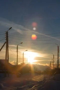 Power lines at sunset background in the winter city with colourful clouds Stock Photos