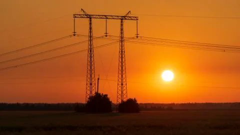 Power lines at sunset in the field Stock Photos