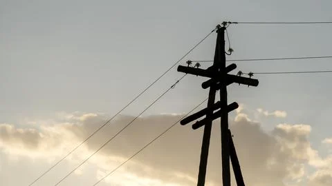 Power lines at sunset in sunlight 스톡 사진