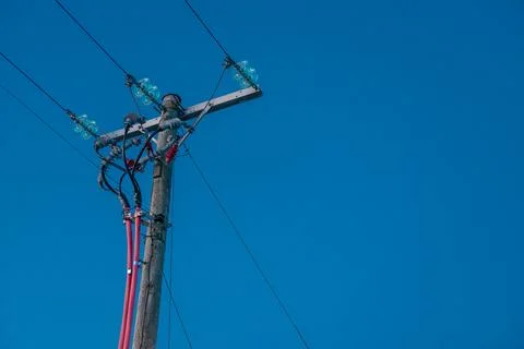 Power lines terminating into a ground cable Stock Photos