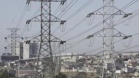 Power lines with a train passing in the background Stock Footage 315536733