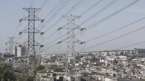 Power lines with a train passing in the background Stock Footage 315536782