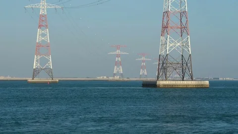Power lines in water or river, long cables and wires in the sky. High voltage of Stock Footage 76367465