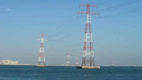 Power lines in water or river, long cables and wires in the sky. High voltage of Stock Footage 76371333