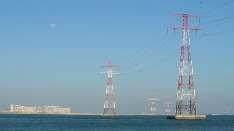 Power lines in water or river, long cables and wires in the sky. High voltage of Stock Footage 76374586