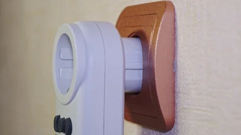 Power meter is inserted into an electrical outlet Stock Footage 103123483