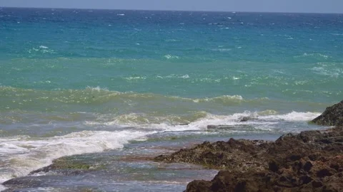 The power of the ocean on display as restless waves collide with the shore,.. Stock Footage 248683157