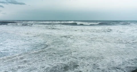 Power of ocean waves breaking splashing sea-spray water foam on the sandy shore 動画素材 143640431